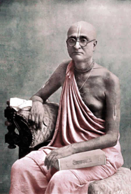 Bhaktisiddhanta sitting with book