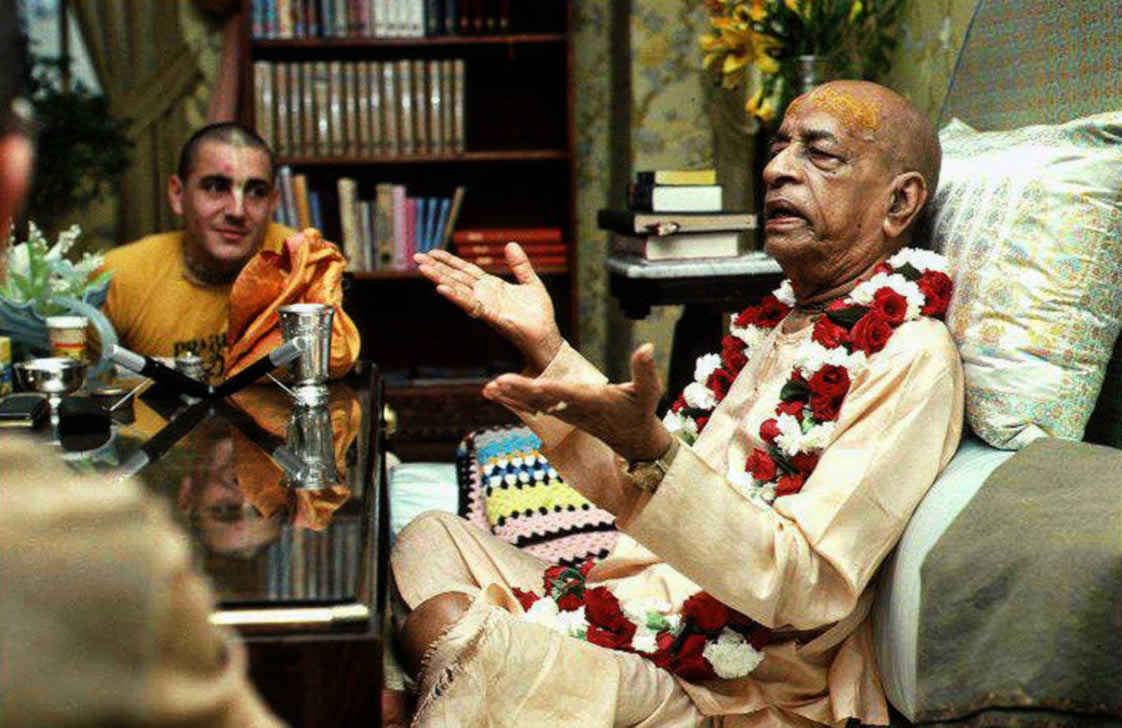 Srila Prabhupada at his desk preaching with Hari Sauri.