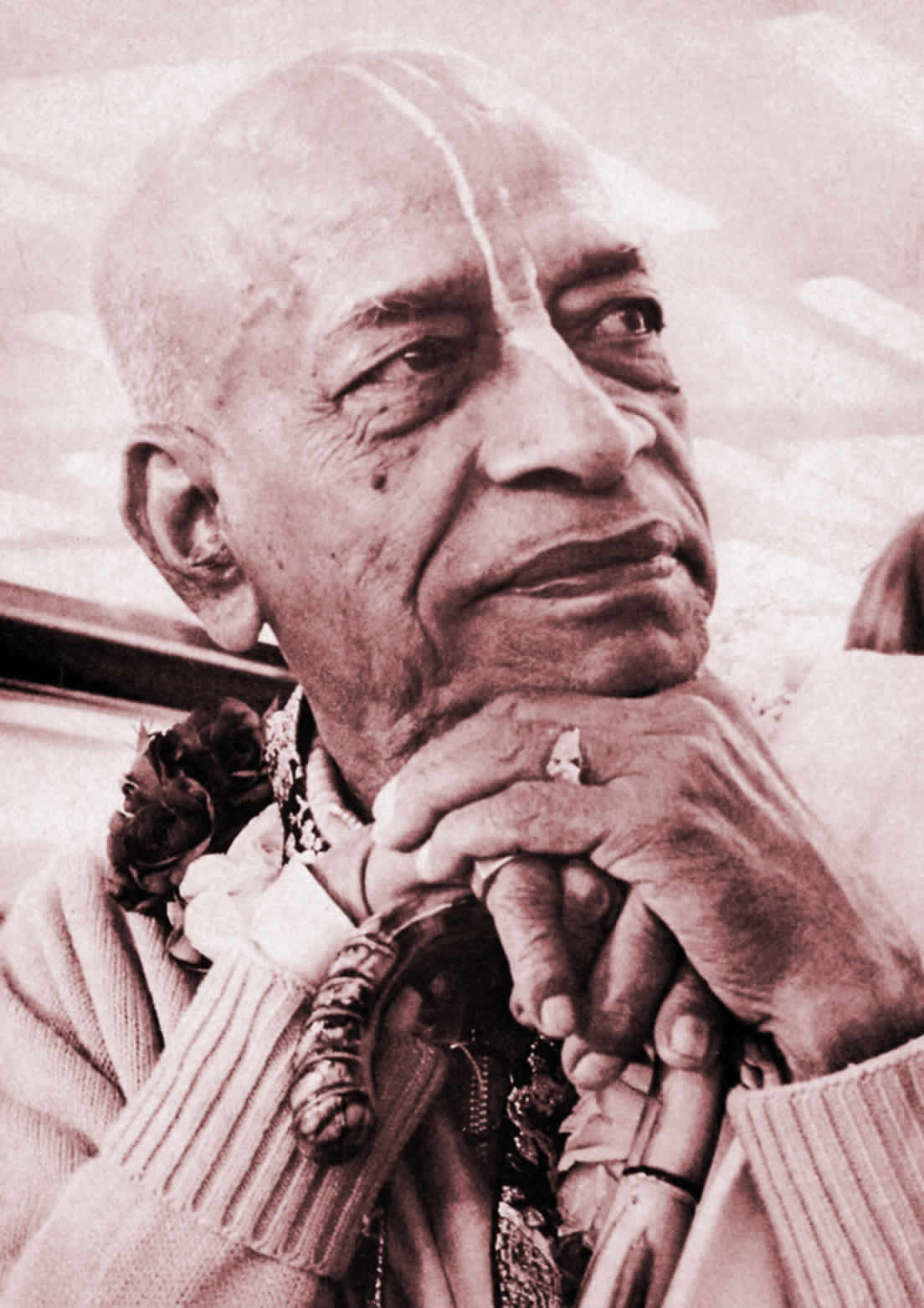 Sepia tone image of Srila Prabhupada resting his chin on his cane.