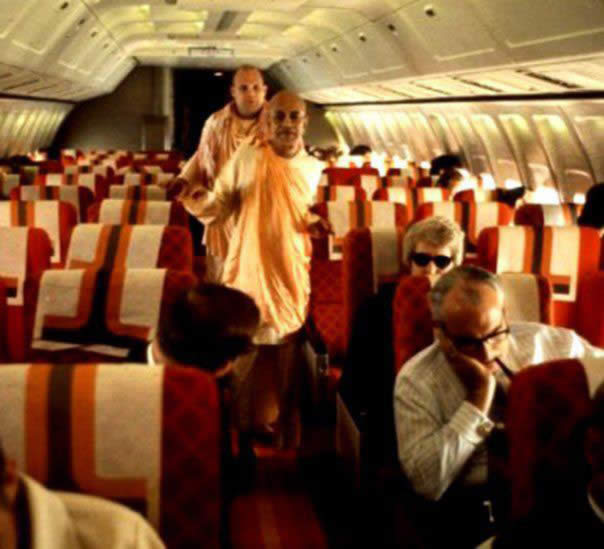 In airplane with Prabhupada