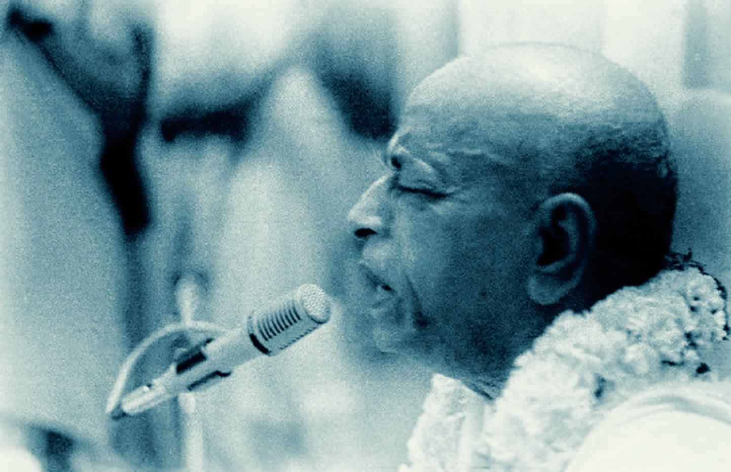 Prabhupada speaking into a mike.