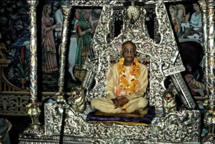 Prabhupada sitting on a silver vyasasana